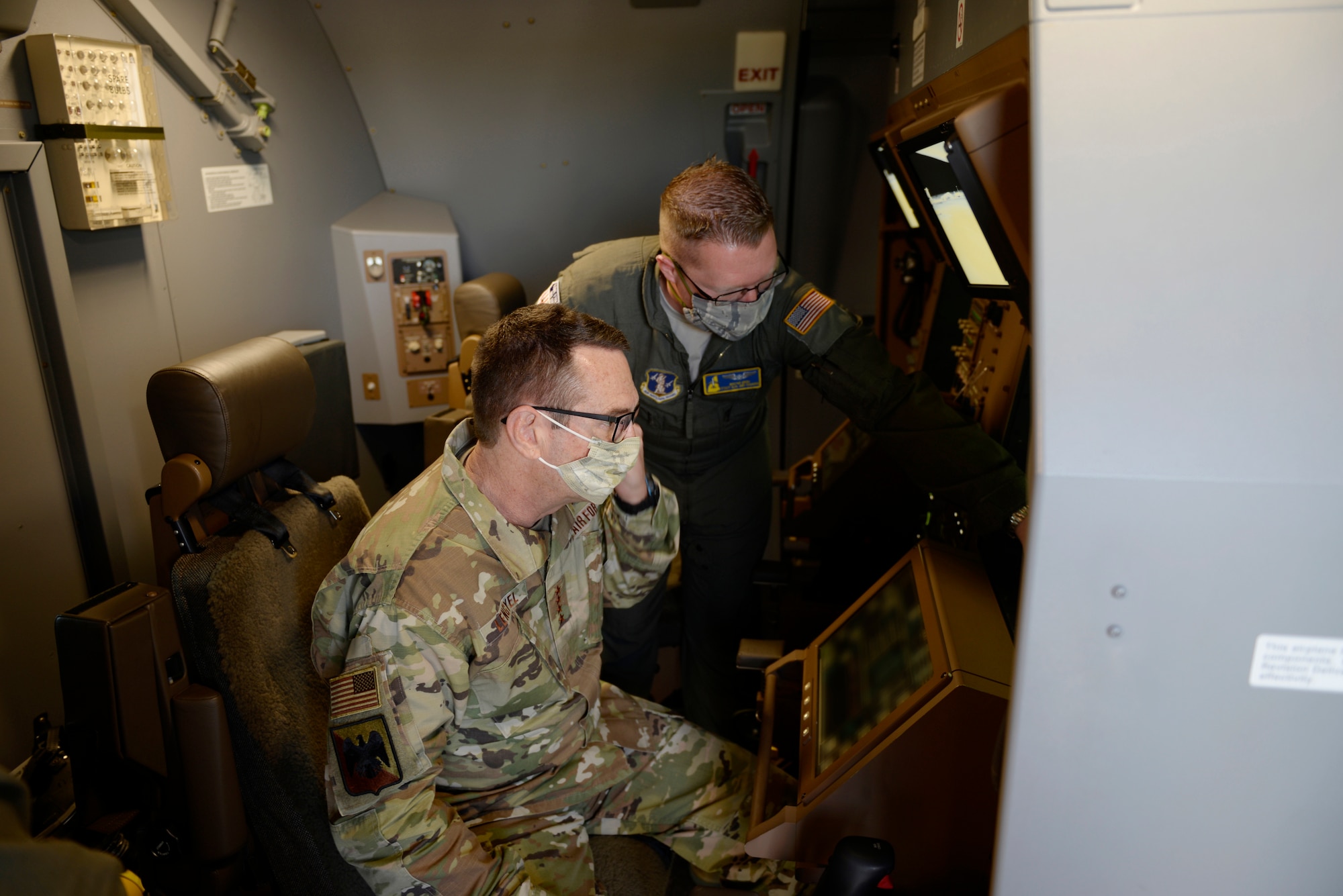 Tech. Sgt. Wayne Reid, a 157th Air Refueling Wing boom operator, demonstrates various aspects of the KC-46A boom controls to Gen. Joseph L. Lengyel, the Chief of the National Guard Bureau, during the general's visit to Pease Air National Guard Base, Newington, N.H., May 27, 2020. (U.S. Air National Guard photo illustration by Senior Master Sgt. Timm Huffman)