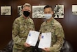 U.S. Army Col. Ian Black, command surgeon for the 1st Theater Sustainment Command, left, and U.S. Army Capt. Yusheng Chen, command dentist for Area Support Group - Kuwait, present their Kuwaiti medical-licenses at the Kuwait Armed Forces Hospital in Sabah Al Salem, Kuwait, May 19, 2020. Black and Chen are the first U.S. military personnel to be medically licensed for practice in Kuwait, an initial step towards medical interoperability between the two nations. (U.S. Army photo by Sgt. Sean Harding)