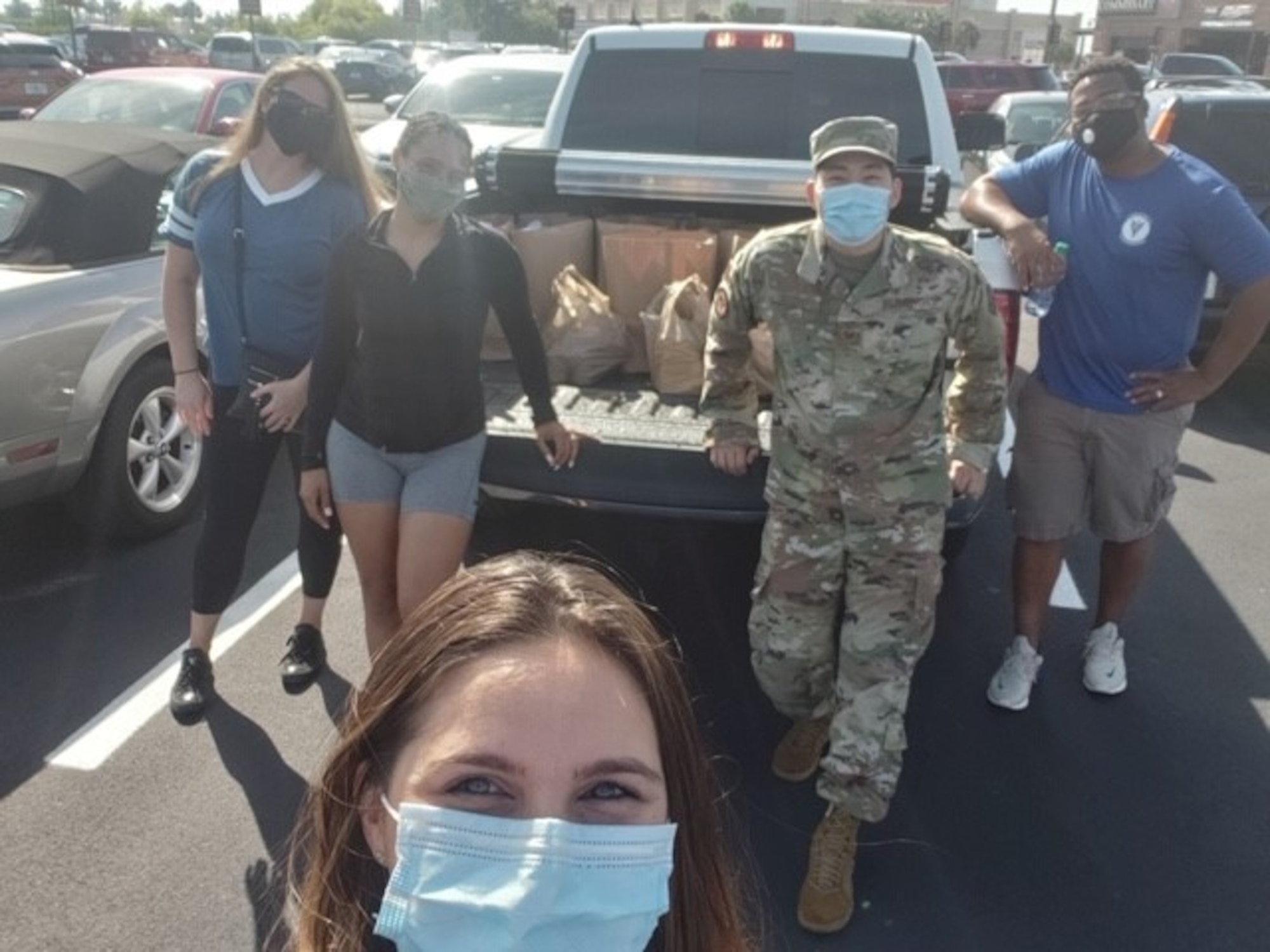Members of the MacDill Air Force Base 5/6 Council, pause for a photo while donating goods for a homeless care drive, May 23, 2020, in Tampa Fla. Council members collected goods at MacDill Air Force Base, Fla., which were donated to the less fortunate in the Tampa community.