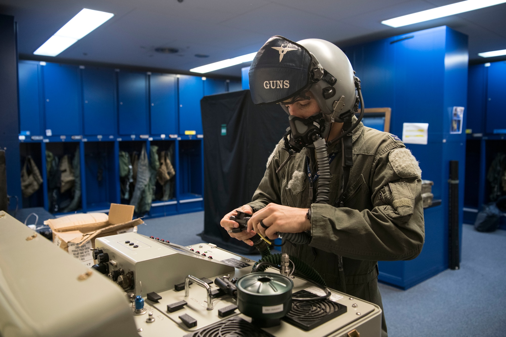 Pilot checks his mask pressure seal.