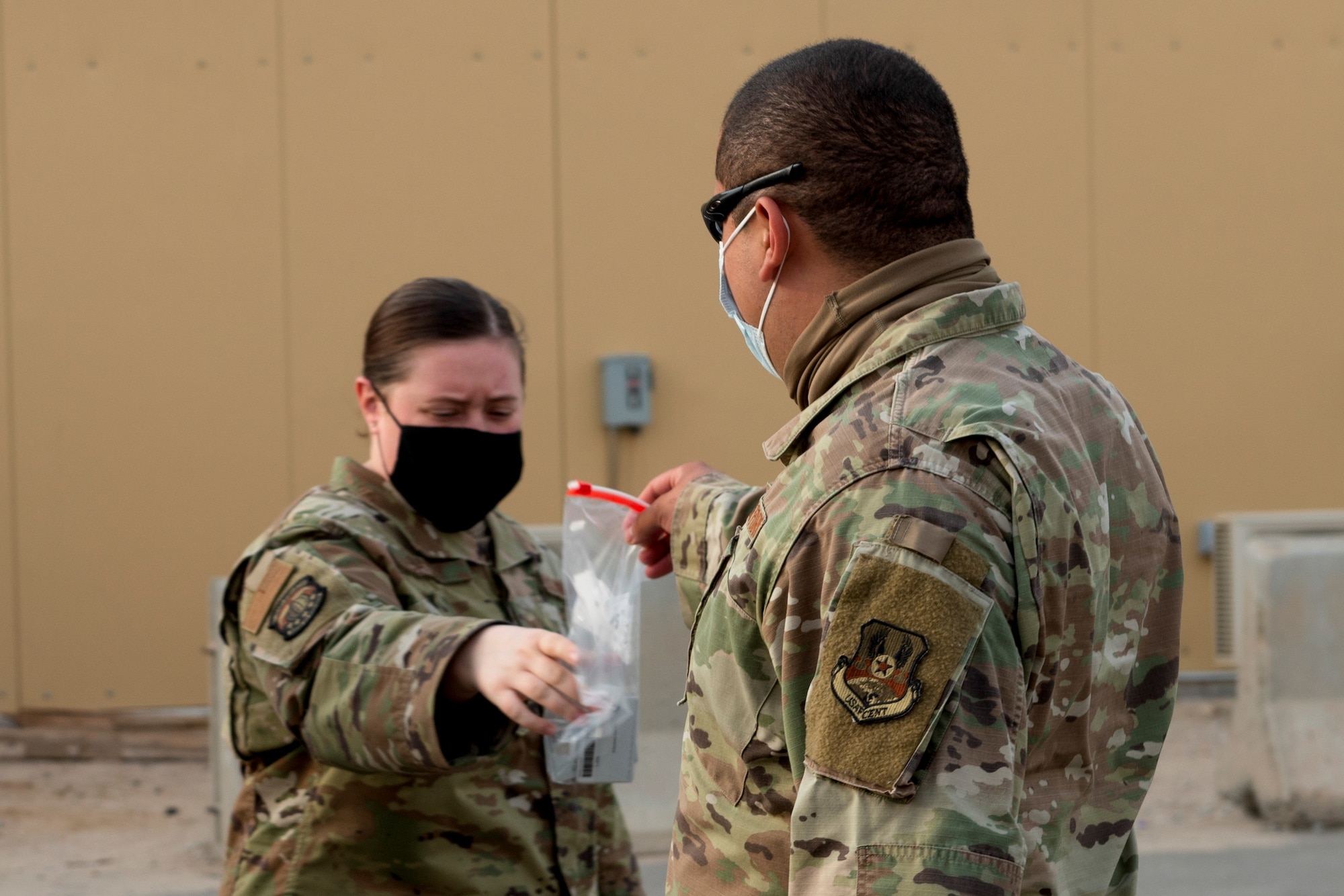 Staff Sgt. Jordan Bailey, 386th Expeditionary Force Support Squadron Personnel Support for Contingency Operations member, collects in-processing paperwork from personnel coming into Ali Al Salem Air Base, Kuwait, May 19, 2020. PERSCO is strictly a deployed environment function and is a vital task to ensure proper accountability takes place within the Area of Responsibility. (U.S. Air Force photo by Senior Airman JaNae Capuno)