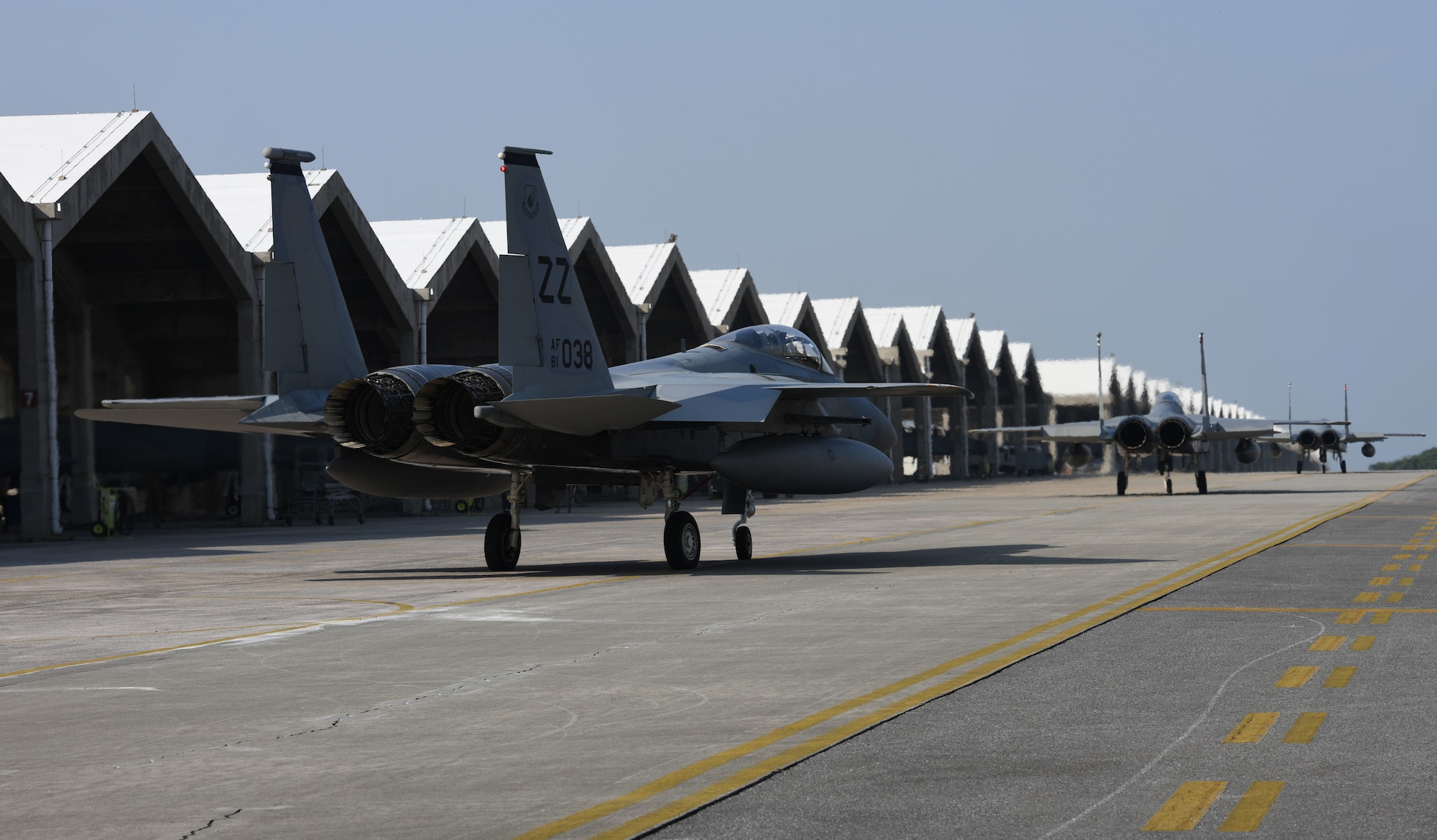F-15C Eagles taxi along the flightline.