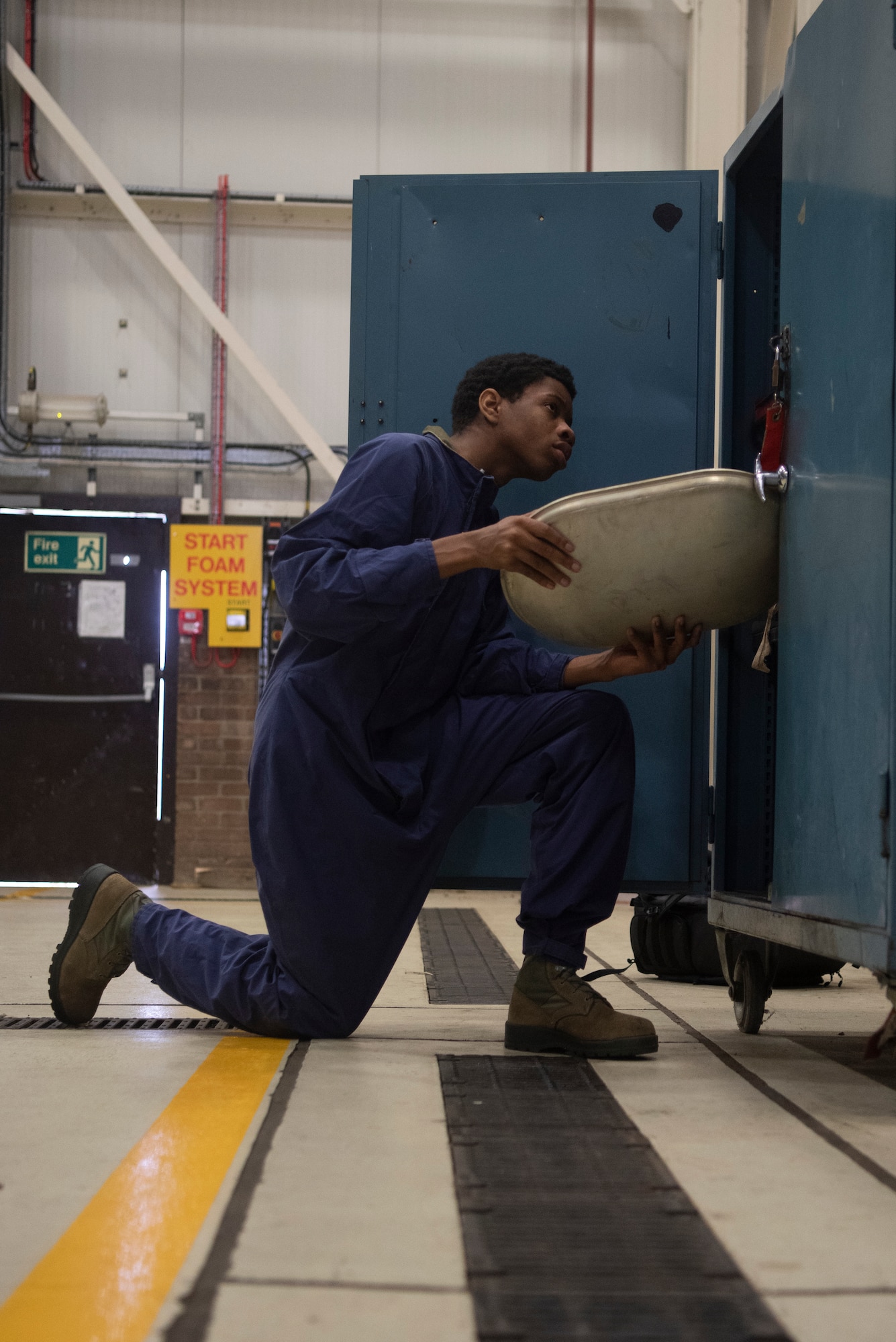 Airman 1st Class Dezmond Ross, 100th Maintenance Squadron fuel systems repair apprentice, deposits a KC-135 access door inside the parts holding bin at RAF Mildenhall, England, May 27, 2020. Parts removed from aircraft are stored in a specific location to maintain their accountability. (U.S. Air Force photo by Airman 1st Class Joseph Barron)