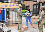 New York Army National Guard Pvt. Mathew Burke, left, from Mechanicville and Pfc. Janelle McKoy from New Windsor, both assigned to the 104th Military Police Battalion, deliver COVID-19 test kits to a nursing facility in The Bronx May 26, 2020.