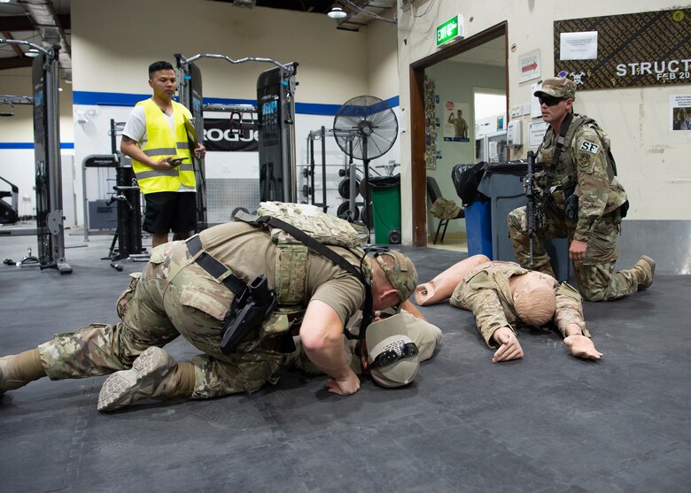 Security Forces members check vitals of casualty