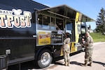 Army soldiers get food from a food truck in Germany.