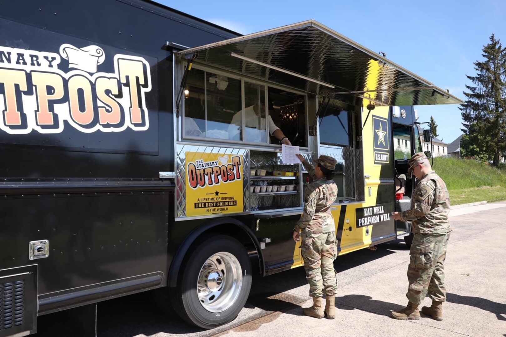 Army soldiers get food from a food truck in Germany.