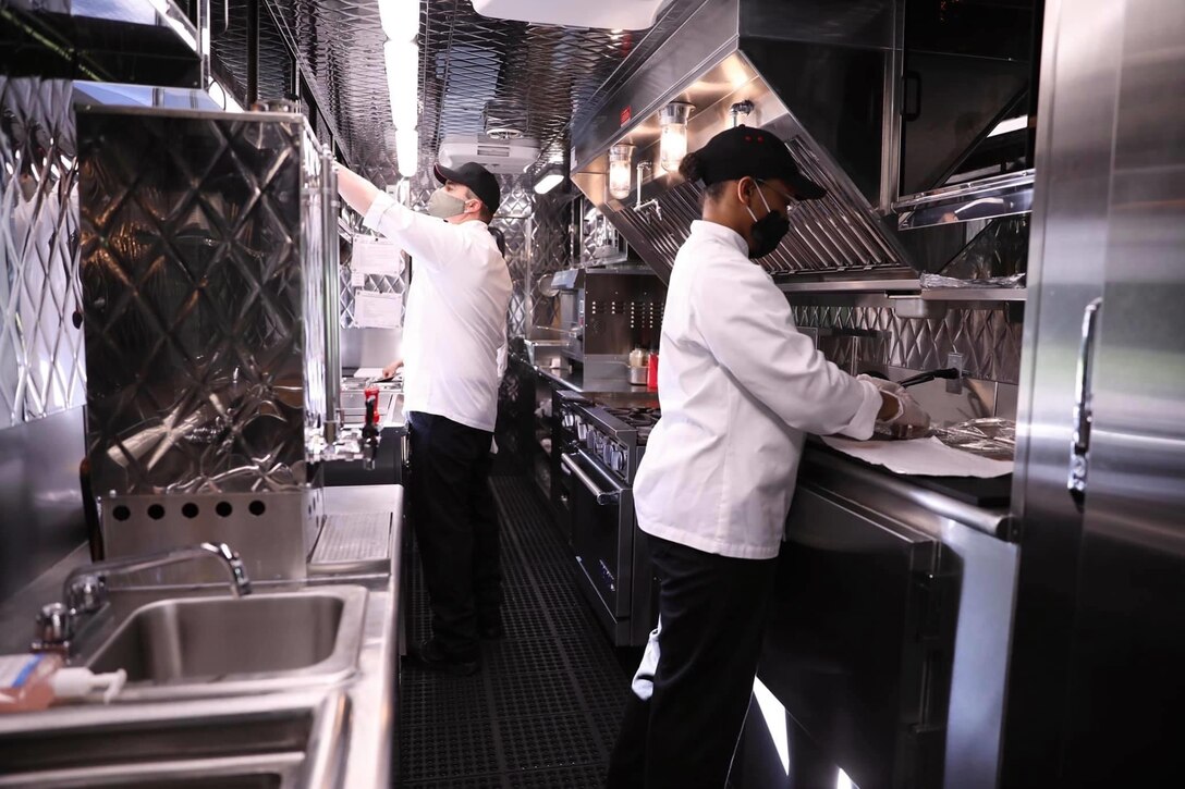 Cooks prepare to work in an Army food truck in Germany.