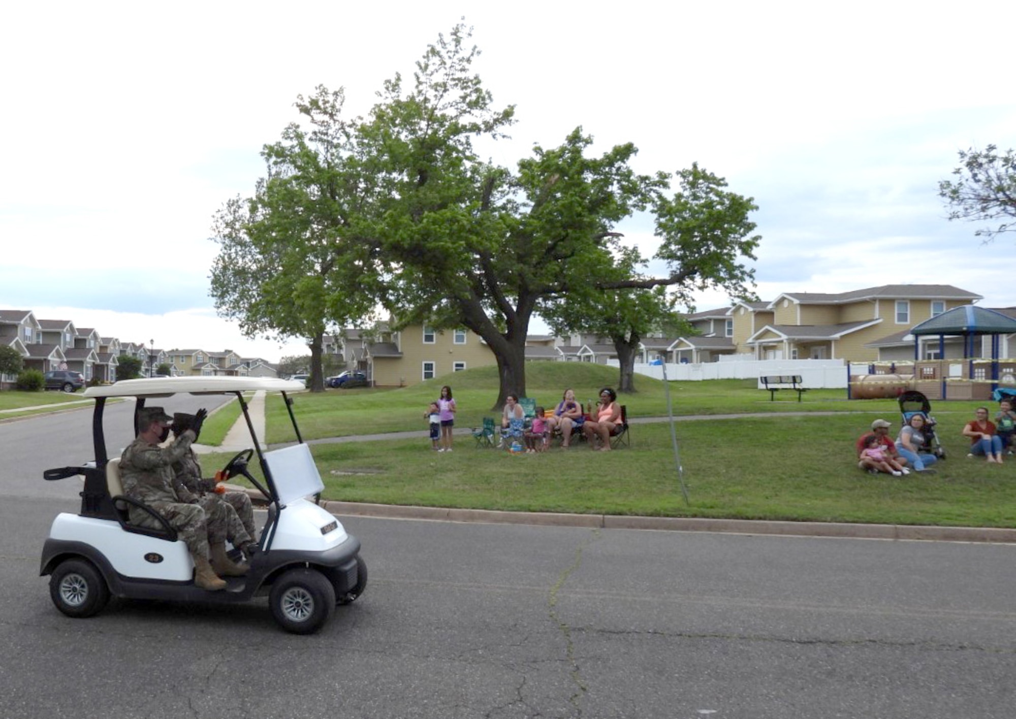 Col. Paul Filcek, 72nd Air Base Wing and Tinker installation commander, waves at base housing residents during the Chalk It Up Parade on May 27. Filcek was joined by several other Tinker leaders, members of base helping agencies, security forces and fire personnel along the parade route.