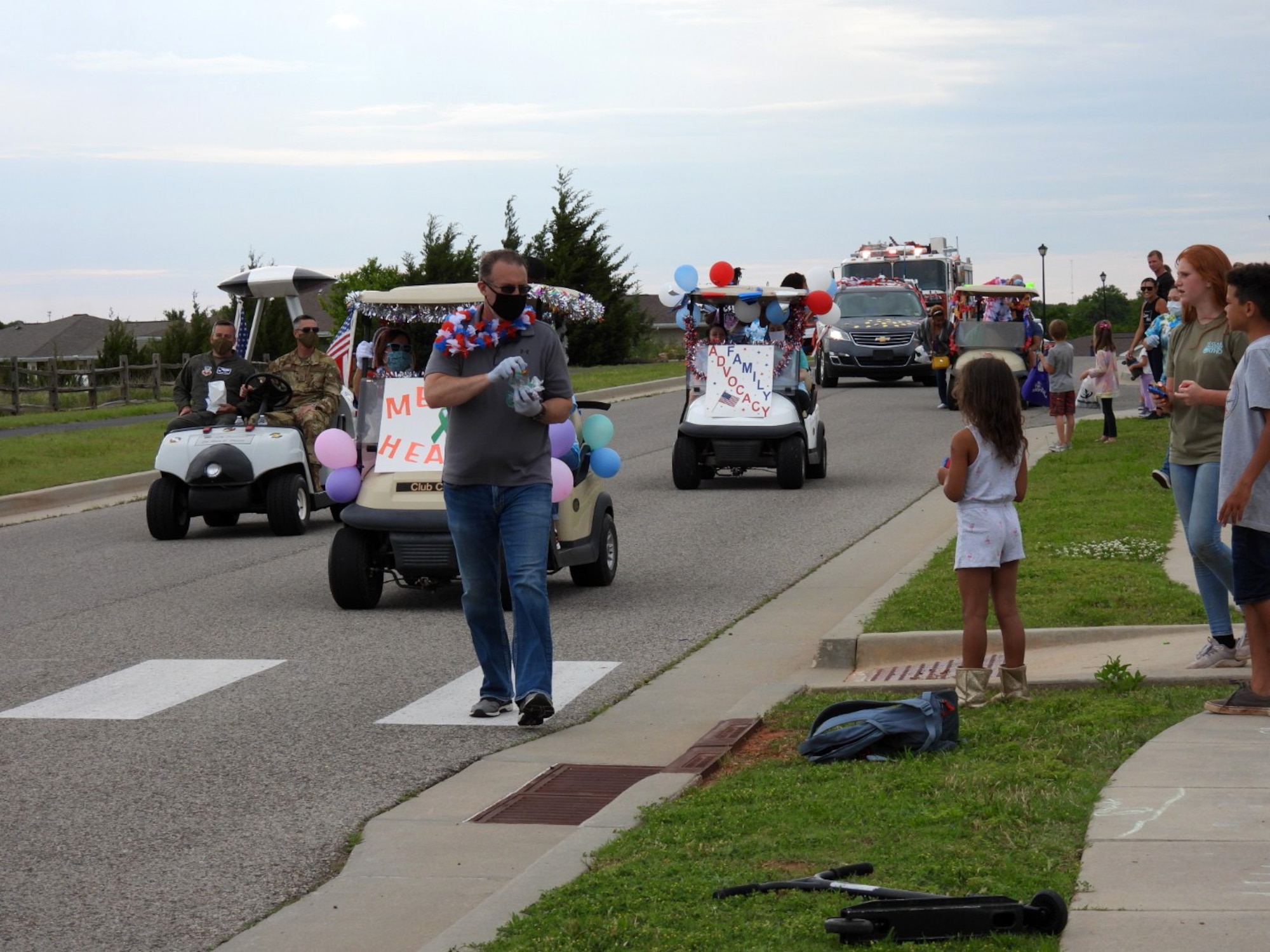 Members of Tinker’s Helping Agencies handed out prepackaged bags of candy and goodie bags along the route of the Chalk It Up Parade May 27. Everyone participating in the parade wore masks and gloves.