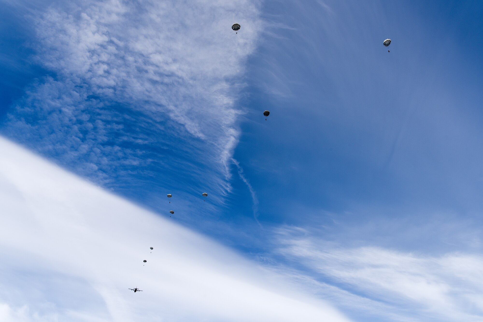 Photo of paratroopers jumping out of an aircraft