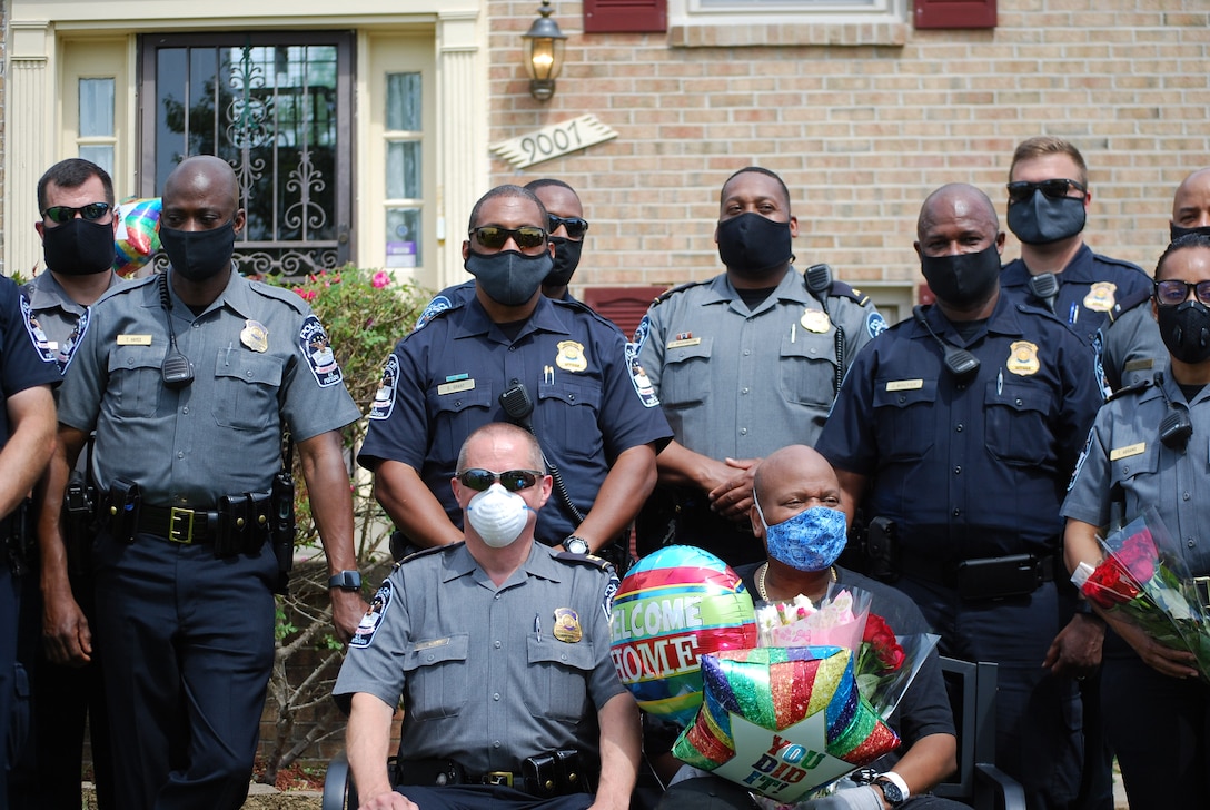 Police wearing protective face masks pose for a group photo.