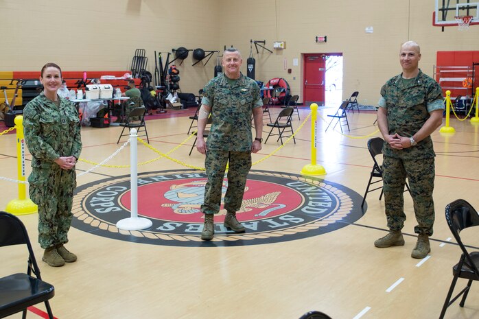 U.S. Marine Corps Lt. Gen. Robert F. Hedelund, the commanding general of U.S. Marine Corps Forces Command (MARFORCOM), Fleet Marine Force Atlantic (FMFLANT), center, Col. Mark R. Reid, commanding officer of Headquarters and Service Battalion (H&S BN), MARFORCOM, FMFLANT, right, and U.S. Navy Lt. Alisa Agey, left, pose for a photo during an Armed Forces Blood Program (ASBP) blood drive at Hopkins Gymnasium on Camp Elmore, Norfolk, Virginia, May 28, 2020.