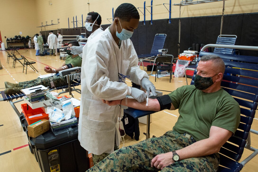 U.S. Marine Corps Lt. Gen. Robert F. Hedelund, the commanding general of U.S. Marine Corps Forces Command (MARFORCOM), Fleet Marine Force Atlantic (FMFLANT), donates blood during an Armed Services Blood Program (ASBP) blood drive at Hopkins Gymnasium on Camp Elmore, Norfolk, Virginia, May 28, 2020. Despite the Coronavirus Disease 2019 (COVID-19) pandemic, ASBP and leaders with Headquarters Service Battalion, MARFORCOM, FMFLANT, coordinated this event to help support the ASBP in their critical mission of blood collection, manufacturing and transfusion of the U.S. military. To donate or get more information about donating during COVID-19 visit https://www.militaryblood.dod.mil/. (U.S. Marine Corps Photo by Sgt. Danielle R. Prentice)