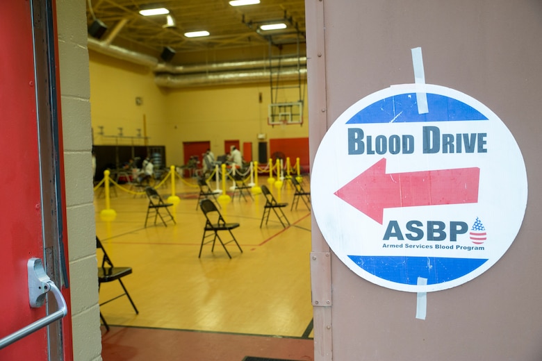 A welcoming signed is posted on the door of the Hopkins Gymnasium during an Armed Services Blood Program (ASBP) blood drive on Camp Elmore, Norfolk, Virginia, May 28, 2020.