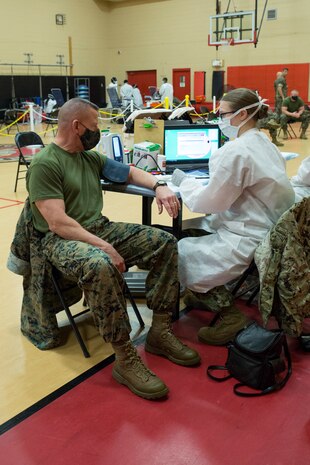 U.S. Marine Corps Lt. Gen. Robert F. Hedelund, the commanding general of U.S. Marine Corps Forces Command (MARFORCOM), Fleet Marine Force Atlantic (FMFLANT), gets his vitals checked during an Armed Services Blood Program (ASBP) blood drive at Hopkins Gymnasium on Camp Elmore, Norfolk, Virginia, May 28, 2020.