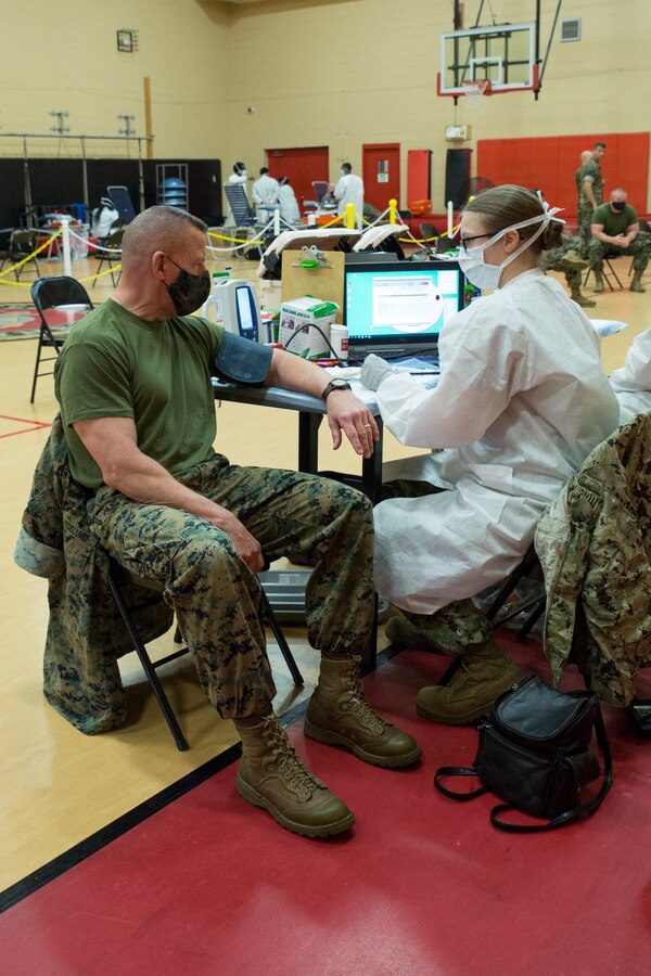 U.S. Marine Corps Lt. Gen. Robert F. Hedelund, the commanding general of U.S. Marine Corps Forces Command (MARFORCOM), Fleet Marine Force Atlantic (FMFLANT), gets his vitals checked during an Armed Services Blood Program (ASBP) blood drive at Hopkins Gymnasium on Camp Elmore, Norfolk, Virginia, May 28, 2020. Despite the Coronavirus Disease 2019 (COVID-19) pandemic, ASBP and leaders with Headquarters Service Battalion, MARFORCOM, FMFLANT, coordinated this event to help support the ASBP in their critical mission of blood collection, manufacturing and transfusion of the U.S. military. To donate or get more information about donating during COVID-19 visit https://www.militaryblood.dod.mil/. (U.S. Marine Corps Photo by Sgt. Danielle R. Prentice)