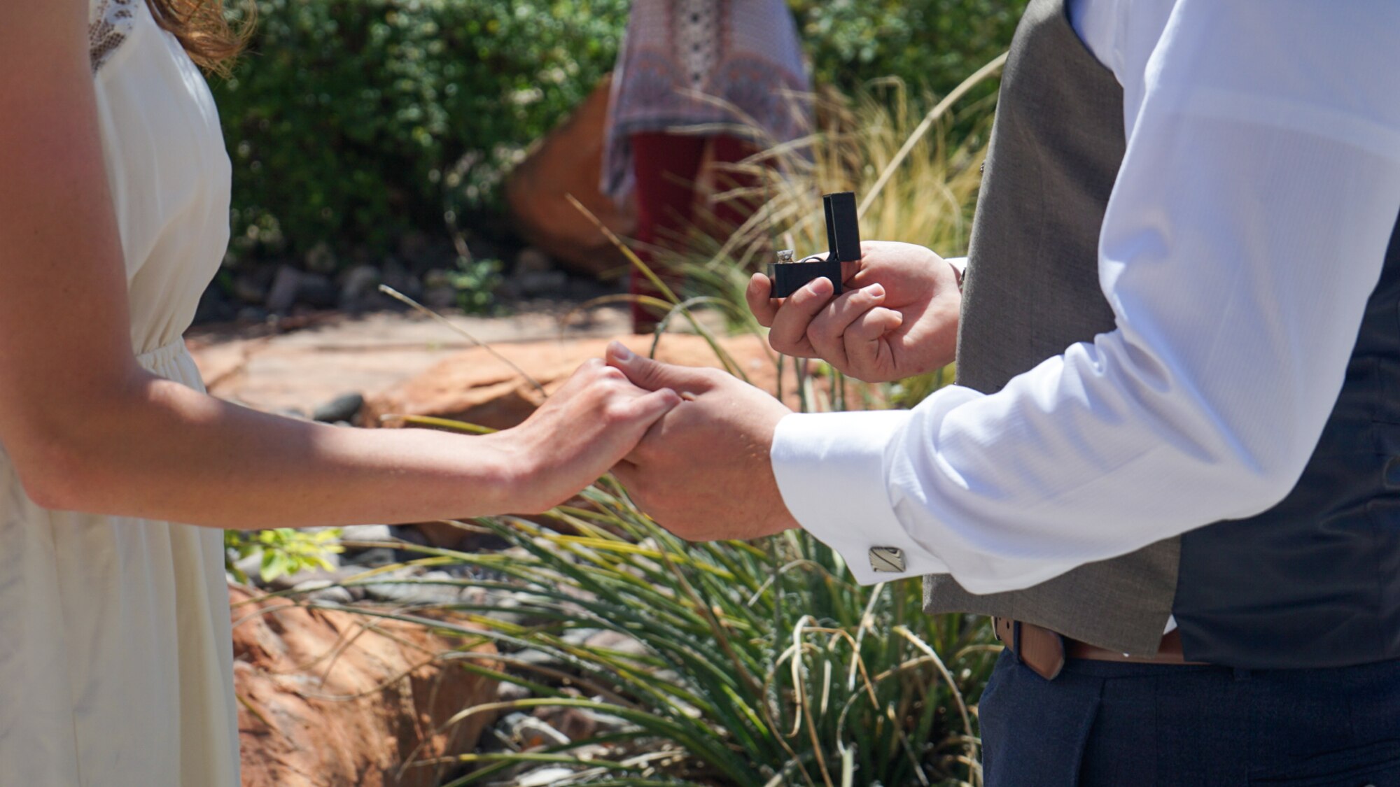 Maj. Corey, 732nd Operations Group director of staff, presents a wedding ring to his wife, Katie, during their marriage ceremony in St. George, Utah.