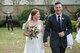 Newlyweds 2nd Lt. Savannah, left, 51st Intel Squadron officer in-charge of targets, and 1st Lt. Riley, right, 482nd Attack Squadron intelligence operations supervisor, walk away from the aisle after getting married in Sumter, South Carolina.