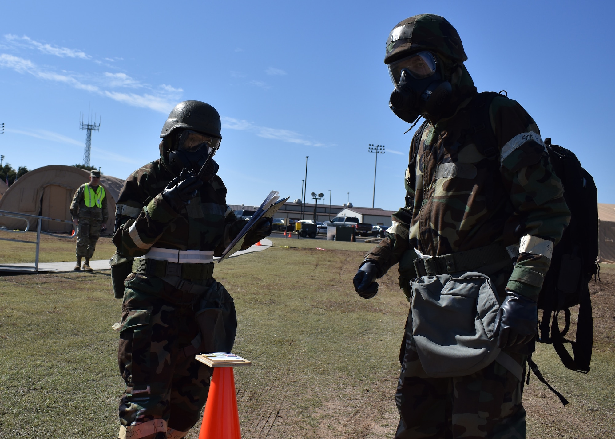 Two Airmen assigned to the 301st Fighter Wing conduct a post attack reconnaissance sweep as a member from the wing inspection team observes them during the Airmen Readiness Training Exercise (ARTEX), November 3, 2019, at U.S. Naval Air Station Joint Reserve Base Fort Worth, Texas. This annual exercise tests the wing's combat readiness through various scenarios which include the ability to survive and operate in a simulated chemically attacked environment. The wing is then evaluated to recognize areas of strength and identify areas needing improvement to ensure mission readiness when called. (U.S. Air Force photo by Staff Sgt. Randall Moose)