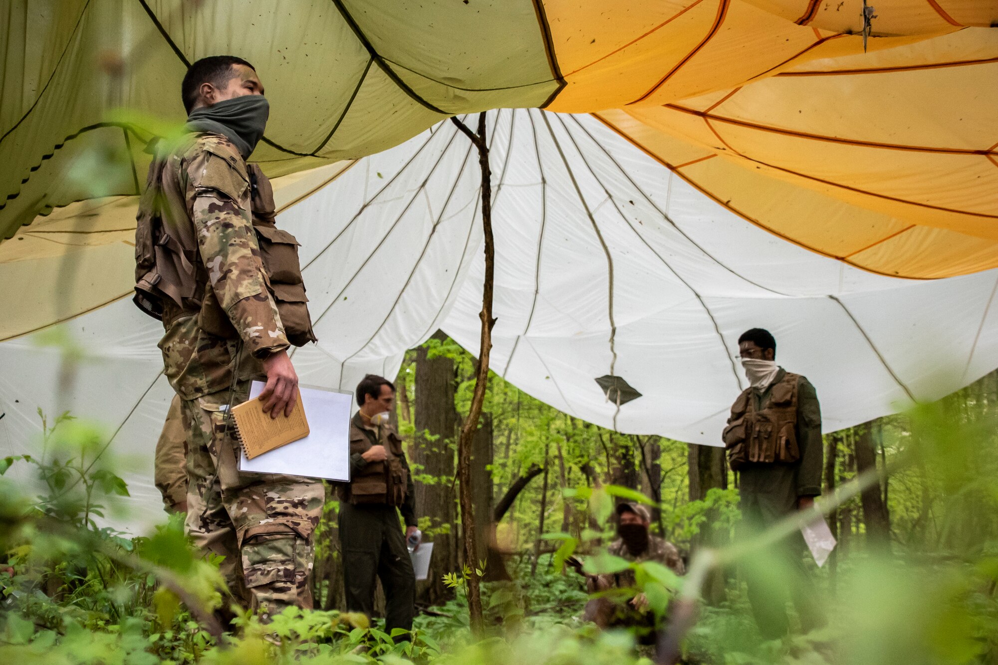 Aircrew from the 179th Airlift Wing Operations Group, Ohio National Guard, participate in combat survival training May 16, 2019, in Butler, Ohio. The 179th AW has made maintaining readiness while abiding by the COVID-19 safety precautions a priority throughout the COVID-19 Pandemic. (U.S. Air National Guard photo by Senior Airman Alexis Wade)