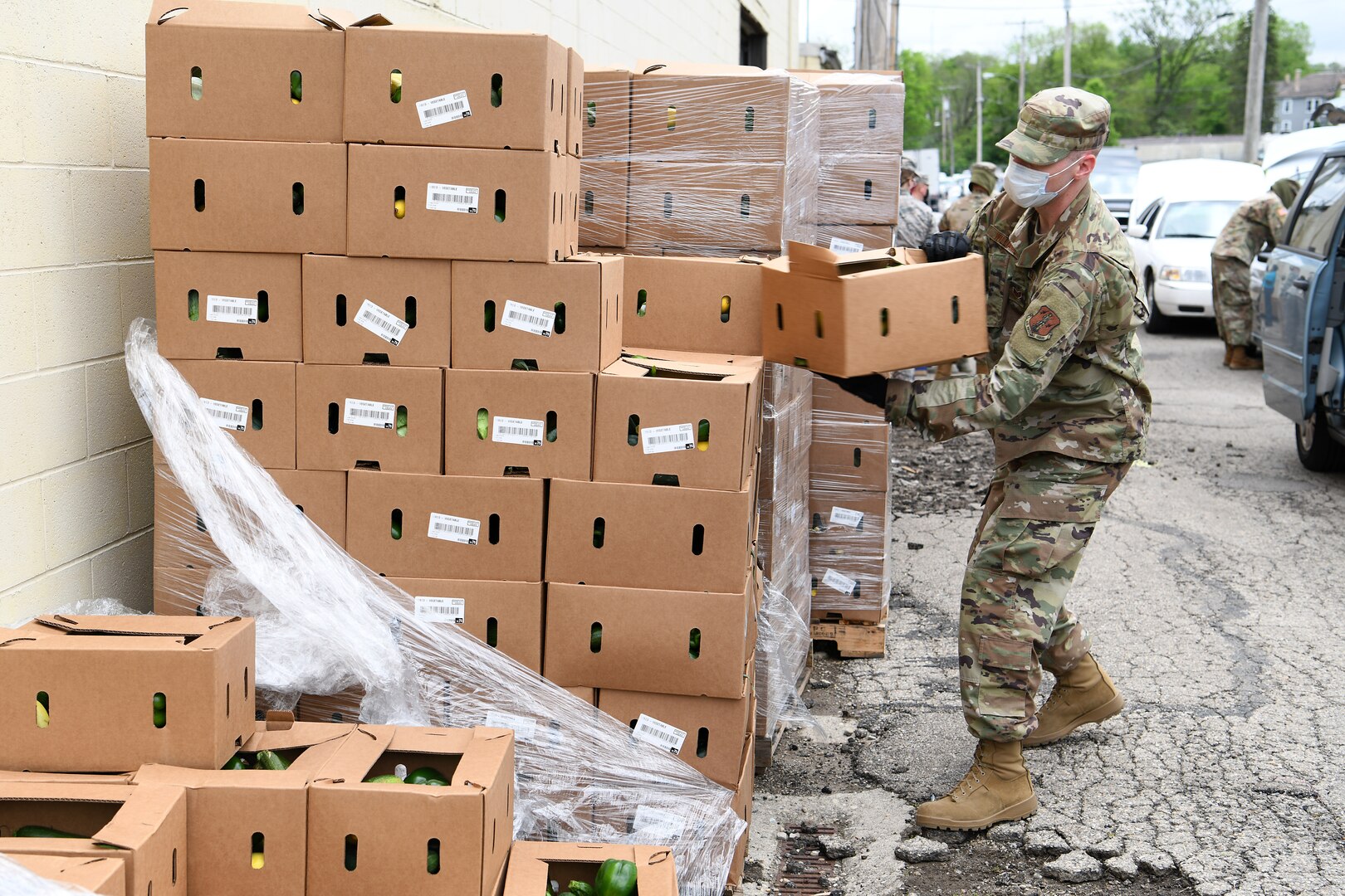 Staff Sgt. Lucas Williams, a radar technician assigned to the 123rd Air Control Squadron, Ohio National Guard, unwraps a pallet of boxes of food during the drive-thru food distribution May 22, 2020, at the Second Harvest Food Bank in Springfield, Ohio.