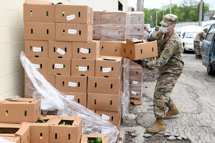 Staff Sgt. Lucas Williams, a radar technician assigned to the 123rd Air Control Squadron, Ohio National Guard, unwraps a pallet of boxes of food during the drive-thru food distribution May 22, 2020, at the Second Harvest Food Bank in Springfield, Ohio.