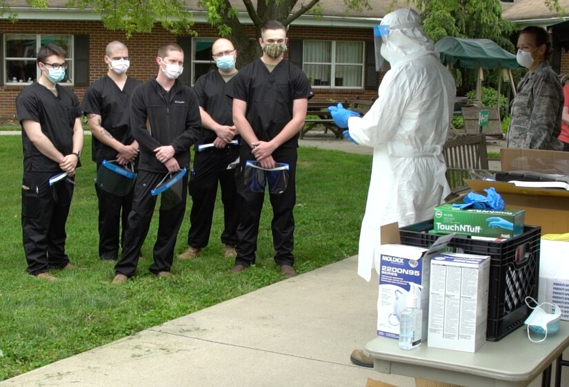 Col. Adam Colombo, senior medical adviser for Task Force-South, trains Task Force Iroquois personnel on proper personal protective equipment procedures at Hickory House Nursing Home in Honey Brook, Pa., on May 22, 2020.