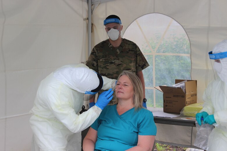 Staff Sgt. Kursty Campbell (Left) and Pfc. Ryan Whispell (Center) test a staff member at Kendal-Crosslands Nursing Home in Kennett Square, Pa., on May 26, 2020.  Under guidance from the Pennsylvania Department of Health, and closely monitored by CDC officials, Pennsylvania National Guard members with Task Force Iroquois, launched a Point Prevalence Sampling Strike Team at Kendal-Crosslands.