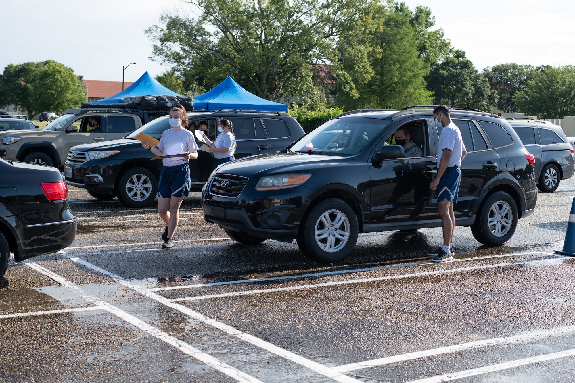 Airmen from the 42nd Military Personnel Flight out process Air Command and Staff College students, May 28, 2020, on Maxwell Air Force Base, Alabama. In order to maintain current safety precautions, the process was modified to allow the students to complete all required paperwork without having to leave their vehicles. (U.S. Air Force photo by Senior Airman Charles Welty)