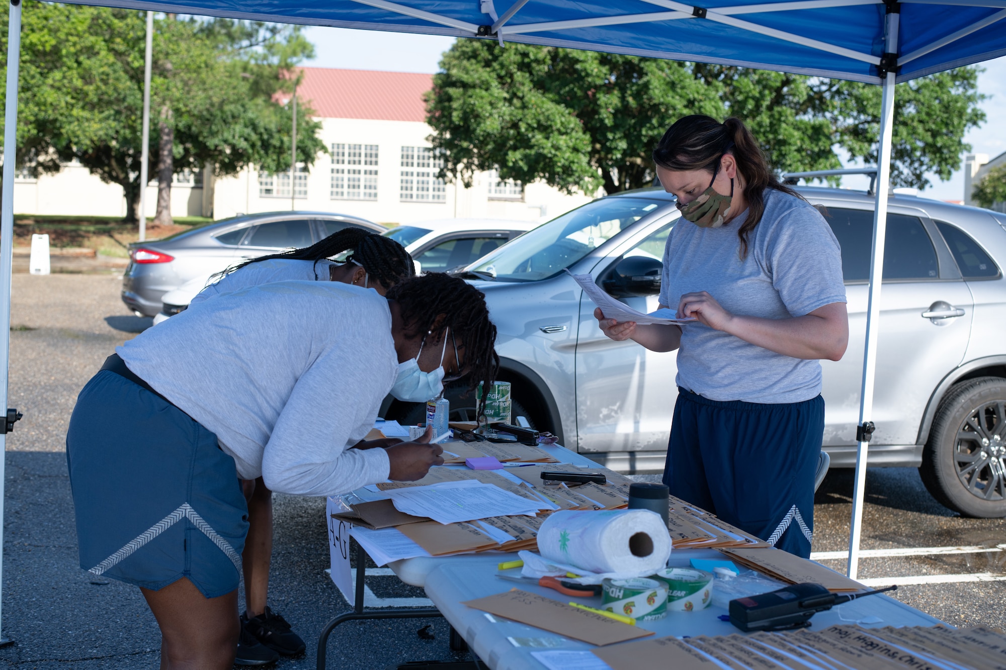 Airmen from the 42nd Military Personnel Flight out process Air Command and Staff College students, May 28, 2020, on Maxwell Air Force Base, Alabama. In order to maintain current safety precautions, the process was modified to allow the students to complete all required paperwork without having to leave their vehicles. (U.S. Air Force photo by Senior Airman Charles Welty)