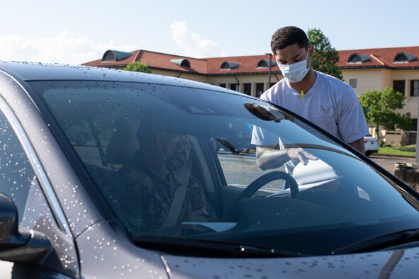 Airmen from the 42nd Military Personnel Flight out process Air Command and Staff College students, May 28, 2020, on Maxwell Air Force Base, Alabama. In order to maintain current safety precautions, the process was modified to allow the students to complete all required paperwork without having to leave their vehicles. (U.S. Air Force photo by Senior Airman Charles Welty)