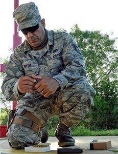 Staff Sgt. Jessie Goytia, 149th Security Forces Squadron member, Air National Guard, loads his ammo during weapons qualification training at a firing range at Joint Base San Antonio-Lackland’s Chapman Training Annex May 27. Members from the 149th SFS received pistol, shotgun and grenade training during the all-day event.