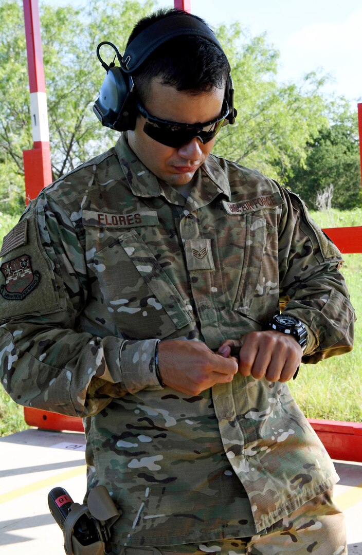 Staff Sgt. Flores, 149th Security Forces Squadron member, Air National Guard, prepares to fire his M-9 pistol during weapons qualification training at a firing range at Joint Base San Antonio-Lackland’s Chapman Training Annex May 27. Members from the 149th SFS received pistol, shotgun and grenade training during the all-day event.