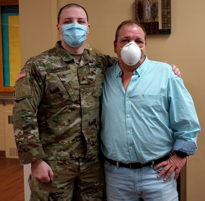 (Left to right) Sgt. Alec Sapienza, combat medic with the 108th Medical Area Support Company, 213th Regional Support Group, Pennsylvania National Guard, and Joseph Sapienza, director of maintenance/ life safety for Pleasant Valley Manor nursing home in Stroudsburg, Pa., pose for a photo on May 21, 2020. Alec volunteered for state active duty during the COVID-19 situation and was tasked with supporting the Pennsylvania Department of Health mission to Pleasant Valley Manor where his father, Joseph, works; a surprise that he found out after he had volunteered to continue to support Pennsylvania (U.S. Army photo by Sgt. 1st Class Matthew Keeler).