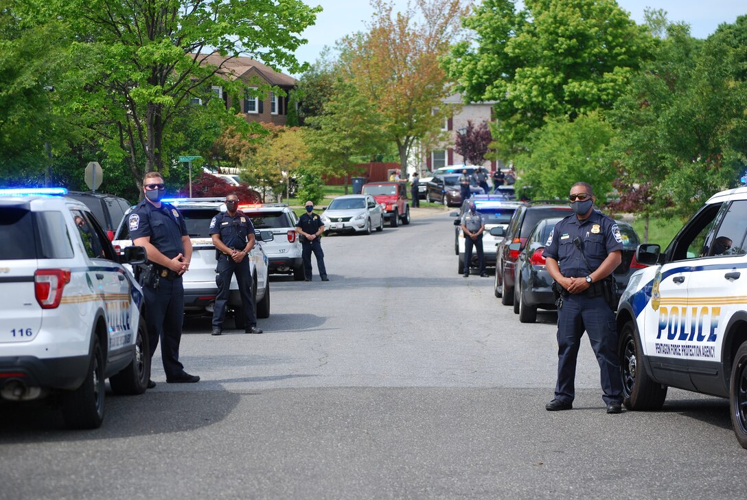 Pentagon Force Protection Agency police officers line the street of Clinton, Maryland, May 15, 2020, to welcome home one of their own, Patrick Bright, who nearly died from COVID-19. (Photo by Pentagon Force Protection Agency)