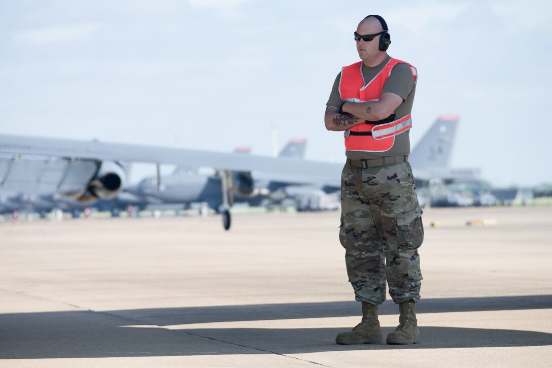 Airman stands outside a B-52