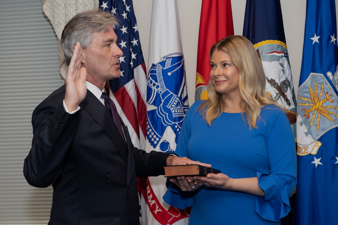 With Ms. Braithwaite holding the Bible, Defense Secretary Mark T. Esper swears-in retired Navy Rear Adm. Kenneth Braithwaite to serve as the next Secretary of the Navy, May 29.