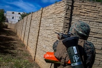 U.S. Marine Corps Lance Cpl. Hector Pereyrabaez, a rifleman with Bravo Company, 1st Battalion, 3d Marine Regiment, posts security during military operations in urban terrain training, Marine Corps Base Hawaii, May 28, 2020. Bravo Company, 1st Battalion, 3d Marine Regiment, and Lima Company, 3rd Battalion, 3d Marine Regiment, conducted an amphibious assault exercise and military operations in urban terrain to increase littoral mobility proficiency in 3d Marine Regiment and advance the goals of the Commandant of the Marine Corps 2030 Force Design. (U.S. Marine Corps photo by Cpl. Matthew Kirk)