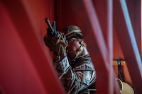 A U.S. Marine with Bravo Company, 1st Battalion, 3d Marine Regiment, posts security during military operations in urban terrain training, Marine Corps Base Hawaii, May 28, 2020. Bravo Company, 1st Battalion, 3d Marine Regiment, and Lima Company, 3rd Battalion, 3d Marine Regiment, conducted an amphibious assault exercise and military operations in urban terrain to increase littoral mobility proficiency in 3d Marine Regiment and advance the goals of the Commandant of the Marine Corps 2030 Force Design. (U.S. Marine Corps photo by Cpl. Matthew Kirk)