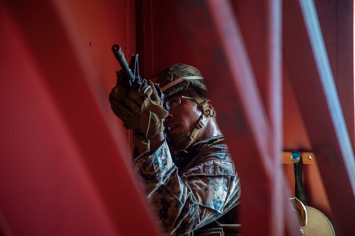 A U.S. Marine with Bravo Company, 1st Battalion, 3d Marine Regiment, posts security during military operations in urban terrain training, Marine Corps Base Hawaii, May 28, 2020. Bravo Company, 1st Battalion, 3d Marine Regiment, and Lima Company, 3rd Battalion, 3d Marine Regiment, conducted an amphibious assault exercise and military operations in urban terrain to increase littoral mobility proficiency in 3d Marine Regiment and advance the goals of the Commandant of the Marine Corps 2030 Force Design. (U.S. Marine Corps photo by Cpl. Matthew Kirk)
