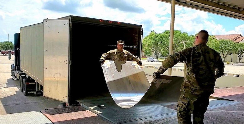 Master Sgt. Juan J. Guerra, a ground transportation section chief/quality assurance, with the 433rd Logistics Readiness Squadron at Joint Base San Antonio-Lackland, Texas helps offload sheet metal with an active duty Airman on May 27, 2020.