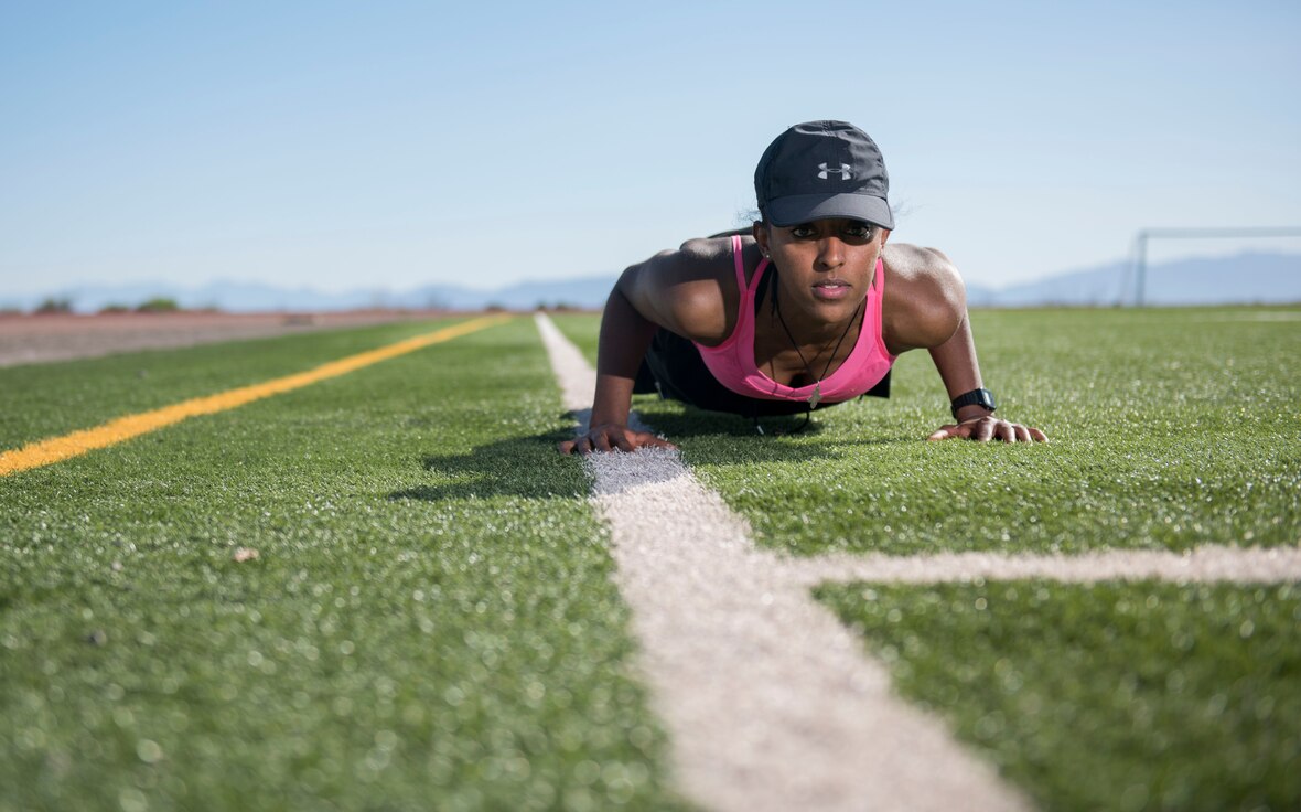 Airman 1st Class Tegist Worku, 49th Maintenance Group maintenance management analysis database manager, does push-ups at the track, May 21, 2020, on Holloman Air Force Base, N.M. During the COVID-19 pandemic, the access to maintain physical fitness has changed for many, while physical fitness has remained crucial for all Airmen mentally and physically. (U.S. Air Force photo by Airman 1st Class Quion Lowe)