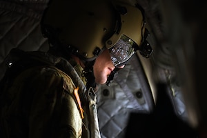 U.S. Army Sgt. Joseph Reddin, a crew chief assigned to the 1st Battalion, 228 Aviation Regiment, based out of Soto Cano Air Base, Honduras, surveys the Central American landscape from a CH-47 Chinook during a Battalion Continuity of Operations (COOP) training flight.