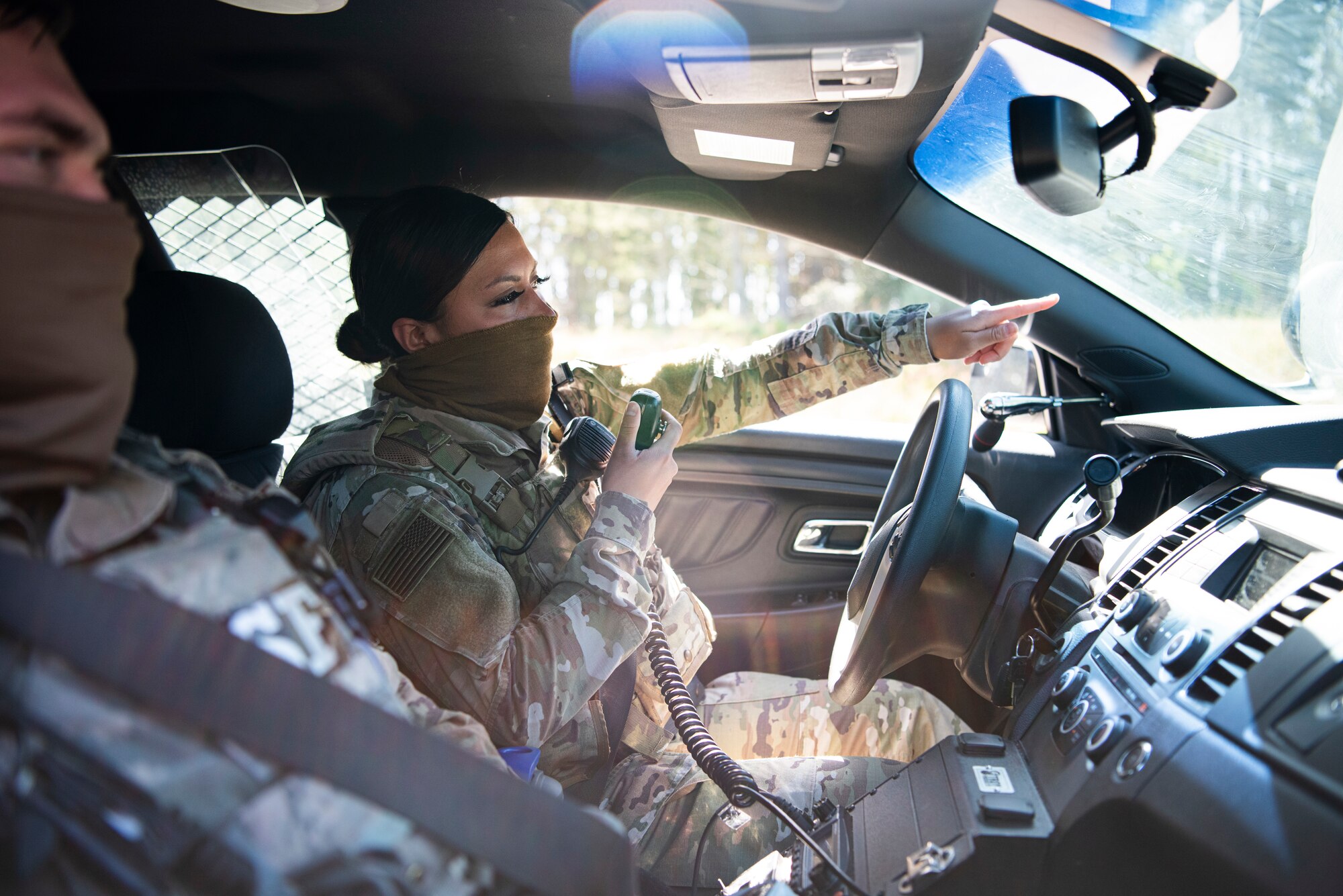 Staff Sgt. Rubi Rivera-Miguel, 30th Security Forces Squadron patrolman, speaks over the radio during a patrol May 20, 2020, at Vandenberg Air Force Base, Calif. Throughout the COVID-19 pandemic, members across the installation were required to wear masks when entering buildings or when they were unable to maintain six-foot distance. While working in law enforcement positions, members come into contact with people from across the community, making it essential to have protective equipment. (U.S. Air Force photo by Senior Airman Hanah Abercrombie)