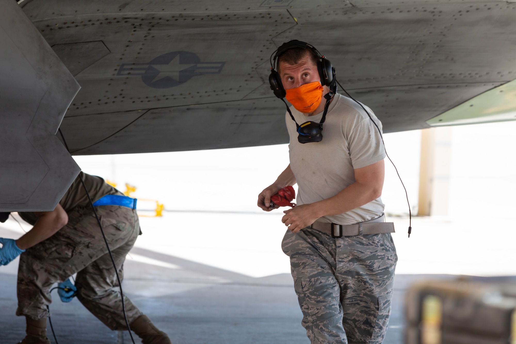 Tech. Sgt. Dustin Packer, 412th Aircraft Maintenance Squadron, conducts a visual inspection of an F-22 Raptor as part of an operational rapid crew swap at Edwards Air Force Base, California, April 30. (Photo courtesy of Kyle Larson/Lockheed-Martin)
