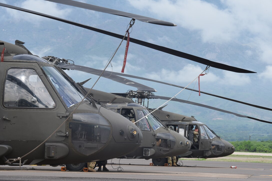 Members of the U.S. Army 1st Battalion, 228th Aviation Regiment conduct pre-flight checks on three UH-60L Blackhawks prior to a Battalion Continuity of Operations (COOP) training flight formation over Honduras and El Salvador, May 28, 2020.