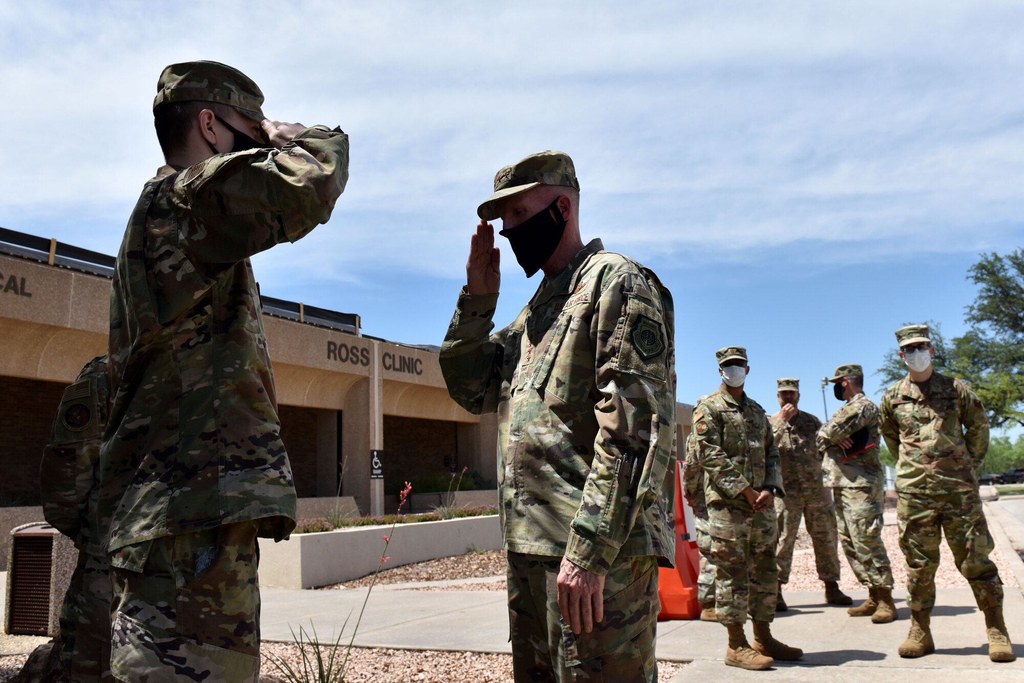 U.S. Air Force Airman 1st Class Stefan Renner, 17th Training Wing Comptroller Squadron network managemnt technician, salutes Gen. Stephen Wilson, vice chief of staff of the Air Force, after being coined in front of the Ross Clinic on Goofellow Air Force Base, Texas, May 29, 2020. During his visit, Wilson coined Airmen nominated by their commanders for their outstanding work during COVID-19. (U.S. Air Force photo by Senior Airman Seraiah Wolf)