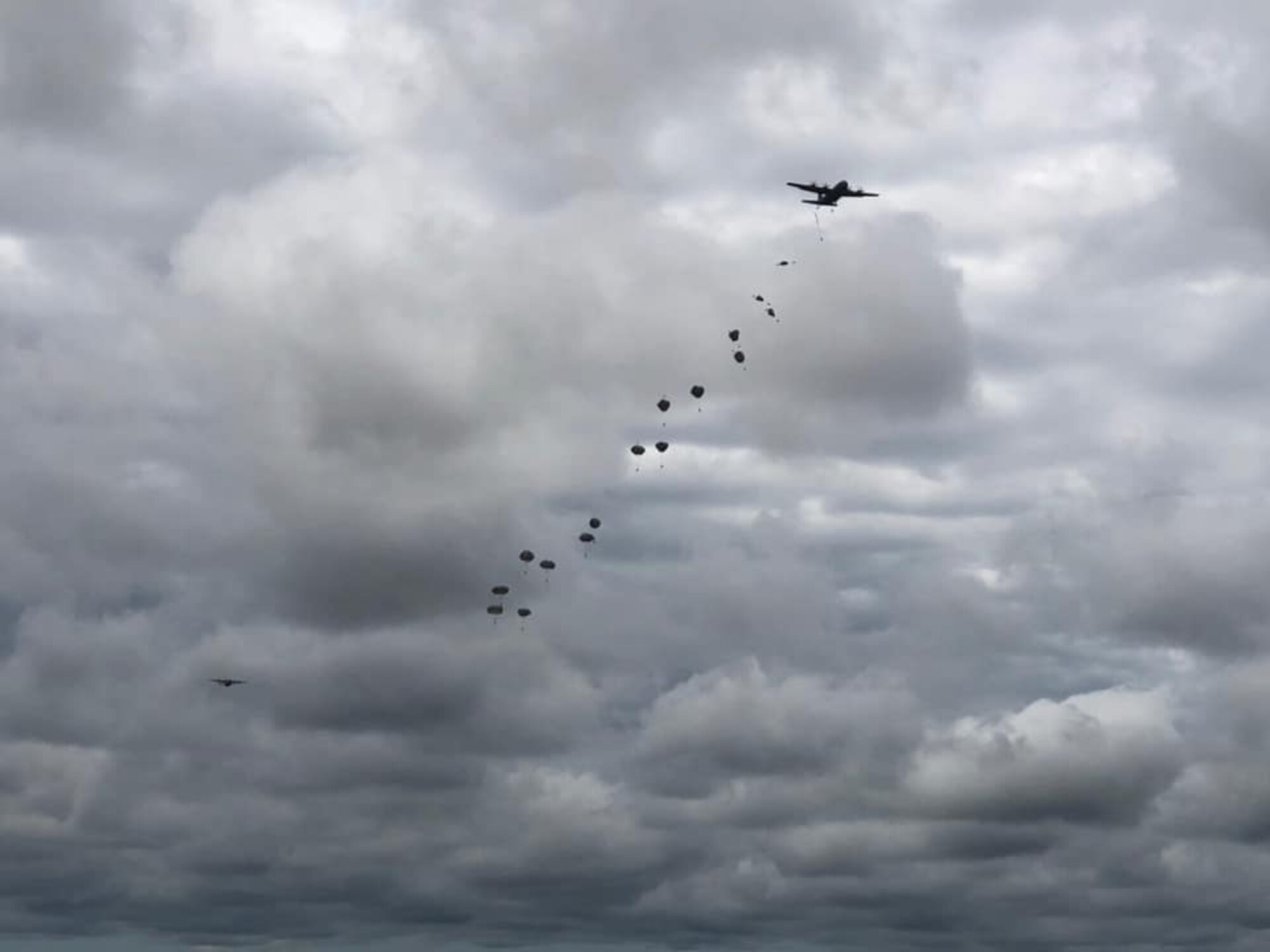 U.S. Army paratroopers descend from the sky after jumping out of C-130J Super Hercules aircraft from Little Rock Air Force Base, Arkansas, in support of airborne operations at the Joint Readiness Training Center in Fort Polk, Louisiana, May 26, 2020. The training allowed more than 140 U.S. Army Soldiers to recertify their status, both as paratroopers and jumpmasters. (Courtesy photo)