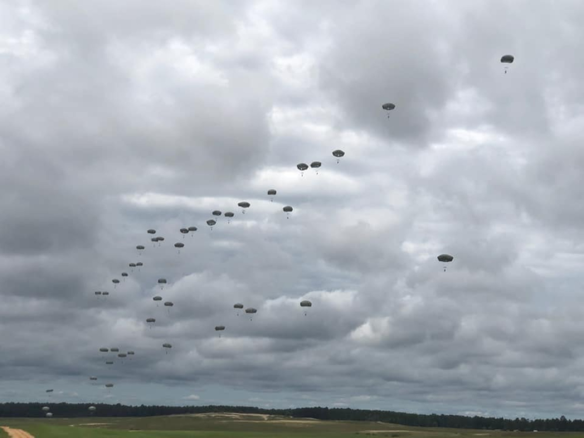 U.S. Army paratroopers descend from the sky after jumping out of C-130J Super Hercules aircraft from Little Rock Air Force Base, Arkansas, in support of airborne operations at the Joint Readiness Training Center in Fort Polk, Louisiana, May 26, 2020. The training allowed more than 140 U.S. Army Soldiers to recertify their status, both as paratroopers and jumpmasters. (Courtesy photo)